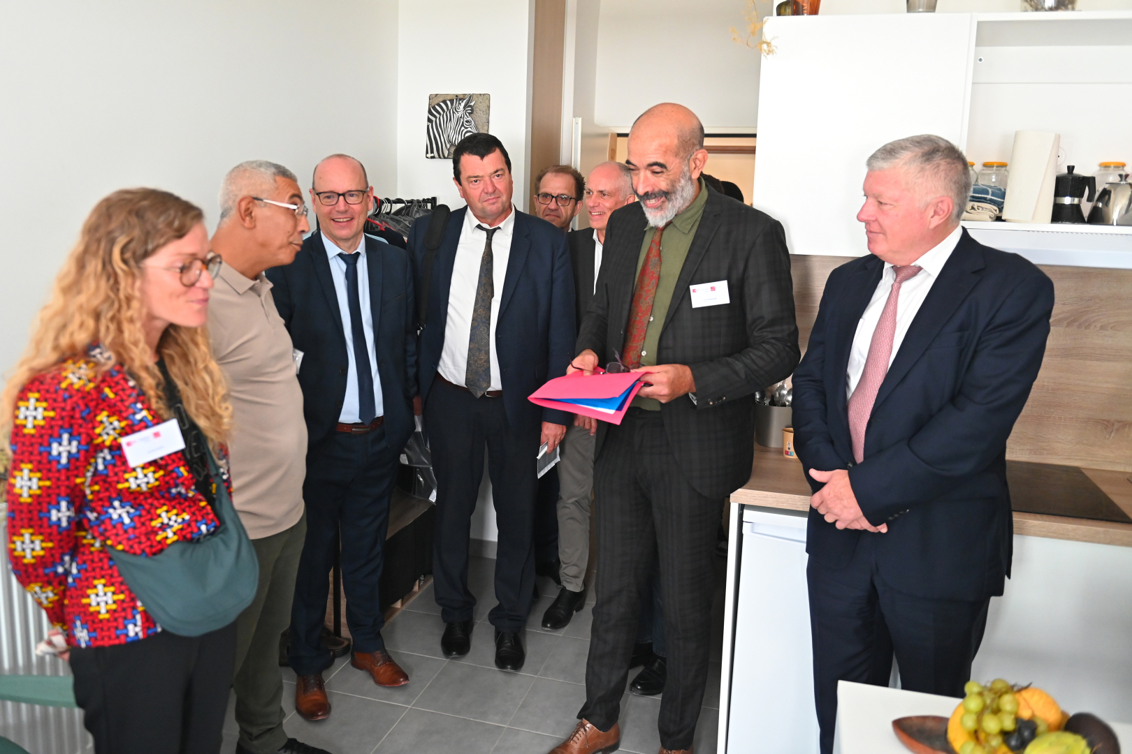 Visite du studio de Tawfik avec notamment Michel Kessouari, directeur départemental d'Adoma, Guy Durand, président d'Action Logement Occitanie (à dte)