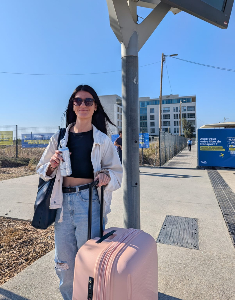 voyageuse avec sa valise à la sortie de la gare batiments affiches inauguration