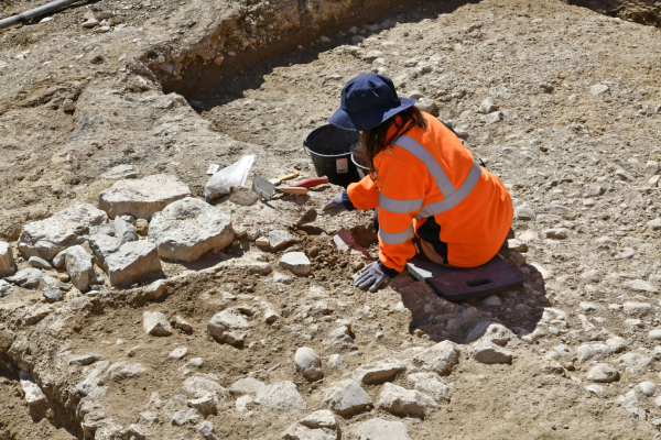 pierres, terre, archéologue au travail avec ses outils 