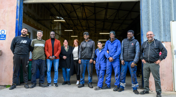 encadrants et personnes en parcours d'insertion professionnelle devant l'atelier du garage solidaire de Passerelles Synergies